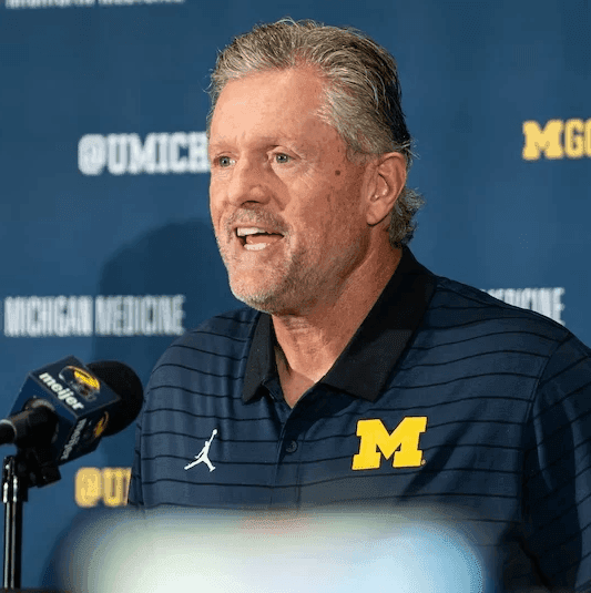 College head coach at a press conference